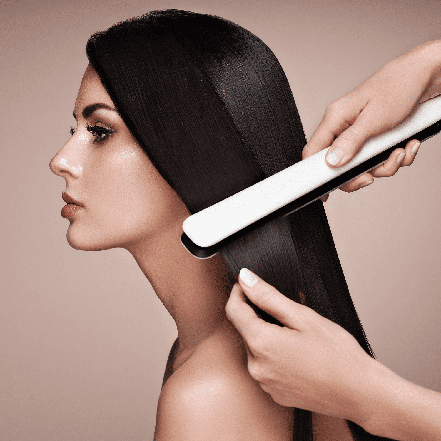 Woman's hair being straightened with a flat iron.